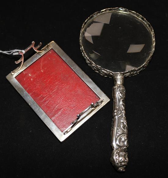 A silver-mounted magnifying glass, foliage, bird and mask-embossed (William Comyns) and a silver and leather-mounted pen stand